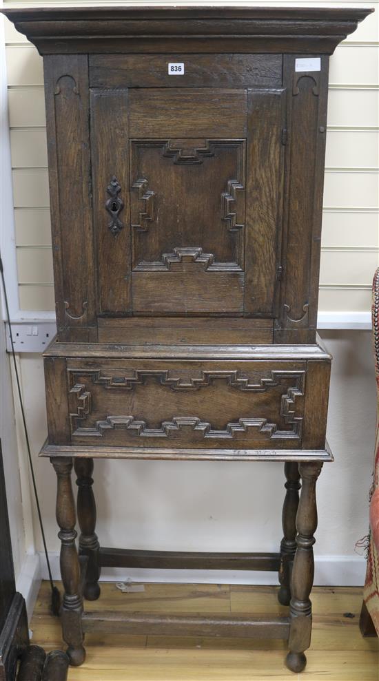 A 17th century style oak cabinet on stand, H.157cm